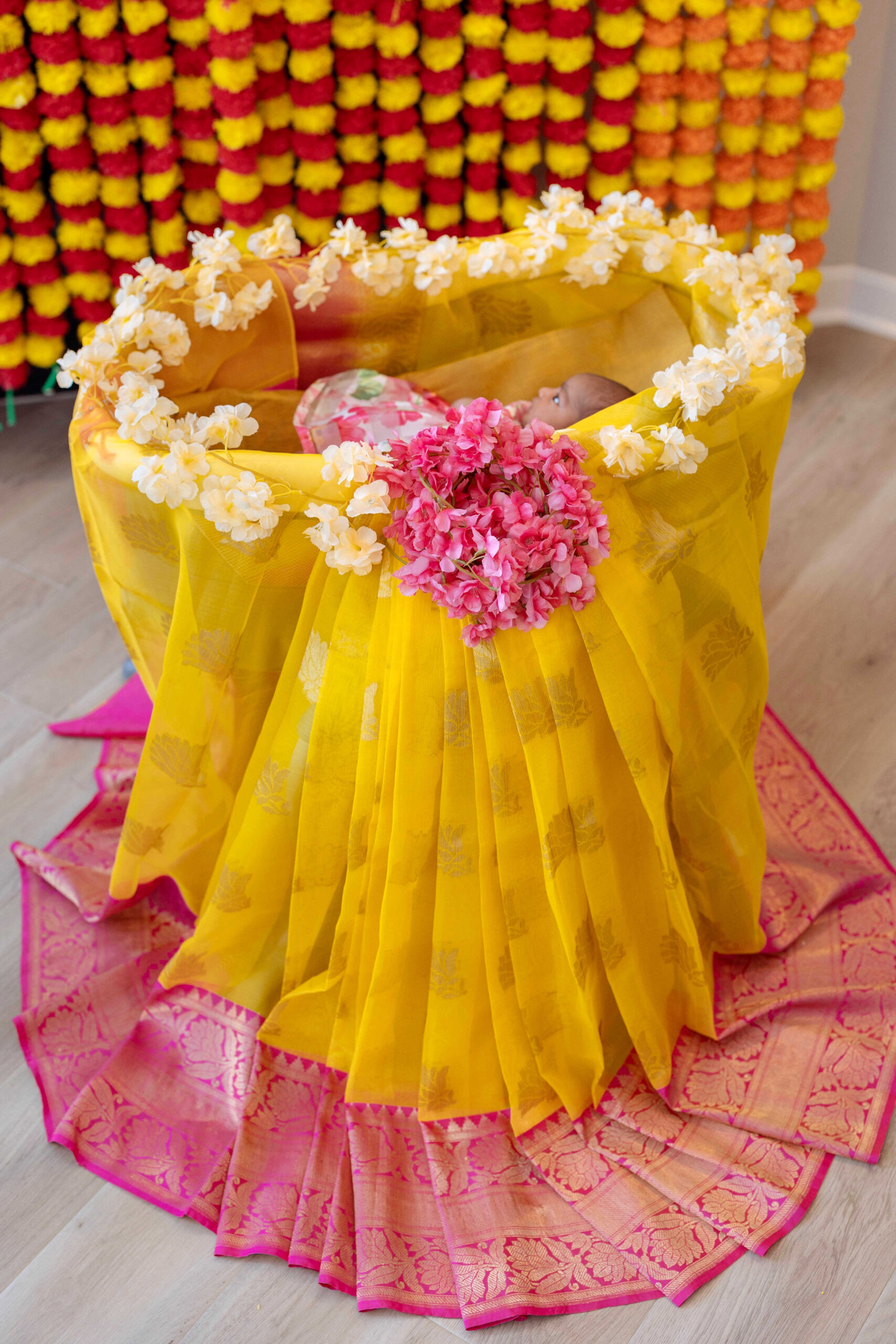 Simple Cradle Ceremony Decoration Ideas in the USA - cradle ceremony decor with a saree by Top US mom blogger Dreaming Loud